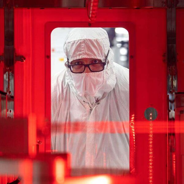 Texas Instruments worker holding semiconductor chips
