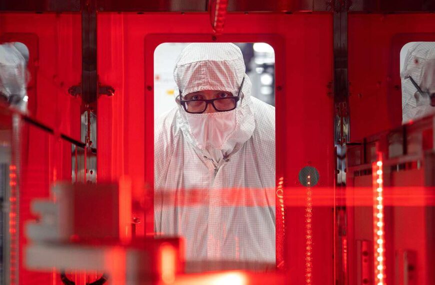 Texas Instruments worker holding semiconductor chips