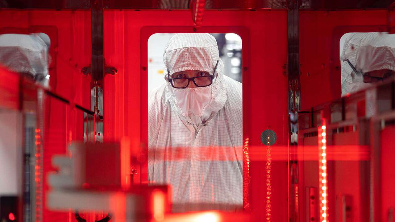 Texas Instruments worker holding semiconductor chips